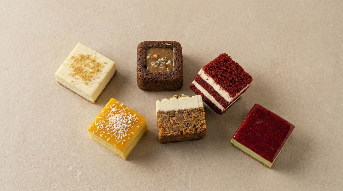 Assortment of individually portioned gluten-free cake and dessert squares: lemon, salted caramel brownie, red velvet, carrot cake and raspberry